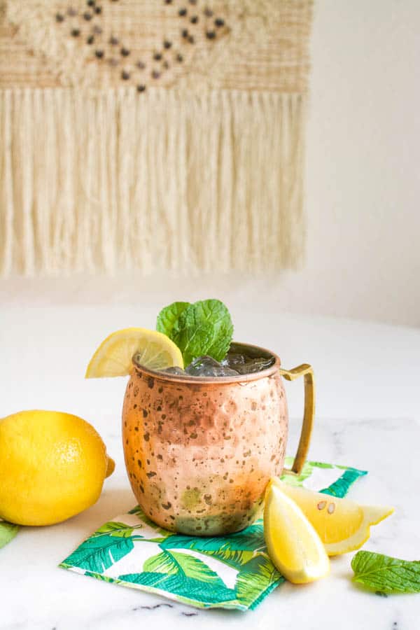 Moscow Mule with lemonade in a copper mug on a table.
