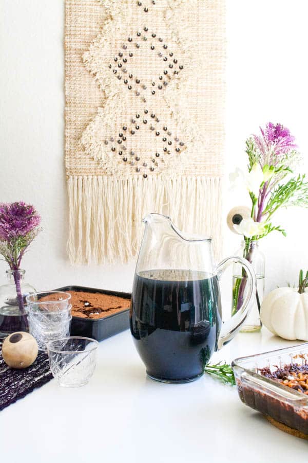 Creepy black Vodka Punch for Halloween on a table.