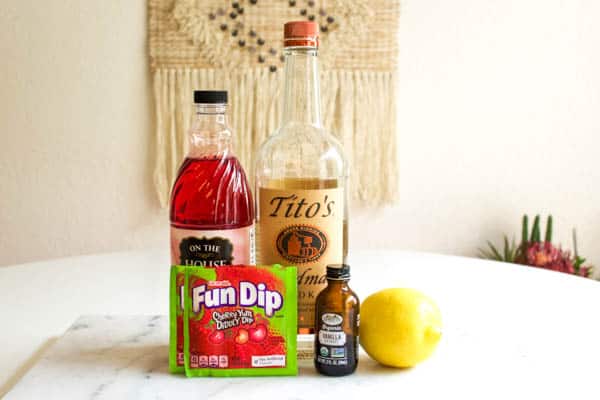 Ingredients on a table to make a Fun Dip candy cocktail. 