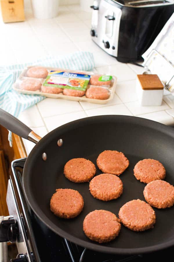Maple Veggie sausage patties cooking in a skillet