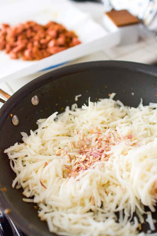 hashbrowns and dried onions in a skillet