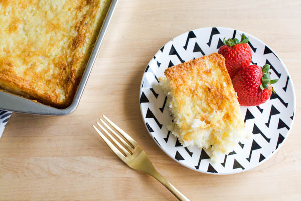 Angel food cake and pineapple dump cake on a plate with fresh strawberries.