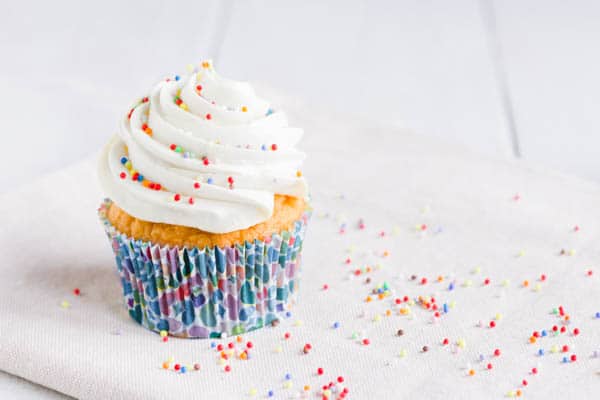 cupcake with vanilla frosting on it.