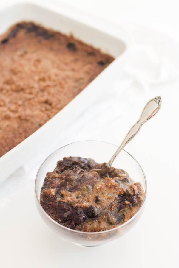 blueberry dump cake with gluten free cake mix in a serving bowl.