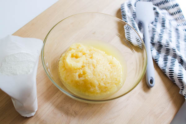 Crushed pineapple in a bowl next to angel food cake mix.