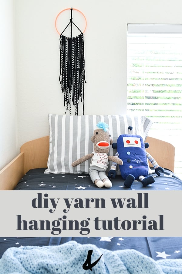 yarn wall hanging above a kid's bed