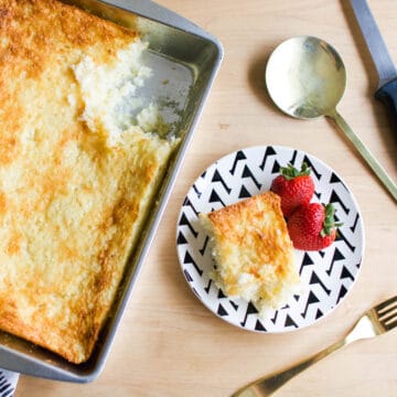 Top down image of a pineapple angel food dump cake in a pan, and a slice with fresh strawberries on a plate.