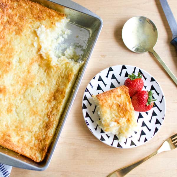 Pineapple angel food dump cake on a dessert plate with a black and white modern design.