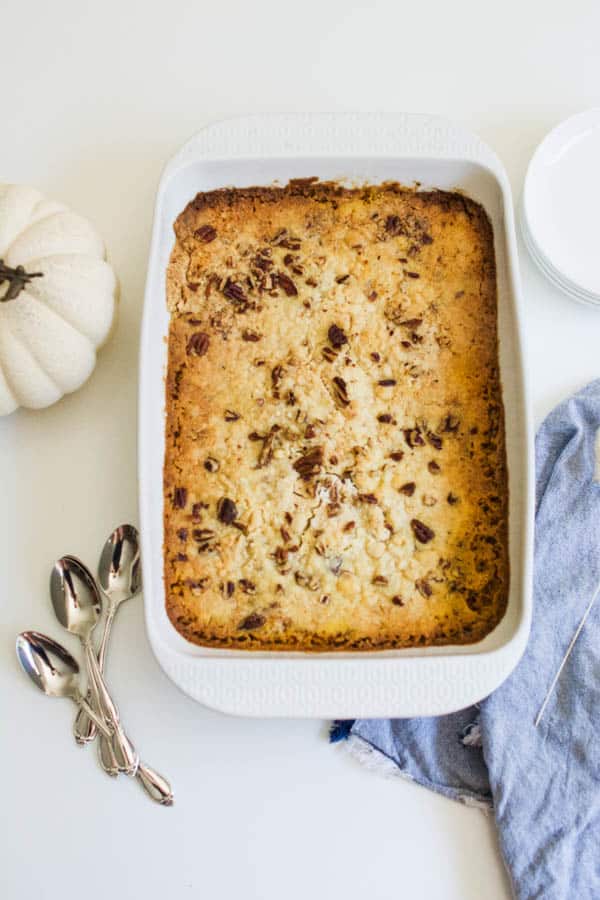 Baking dish with a pumpkin dump cake recipe with no eggs and yellow cake mix.