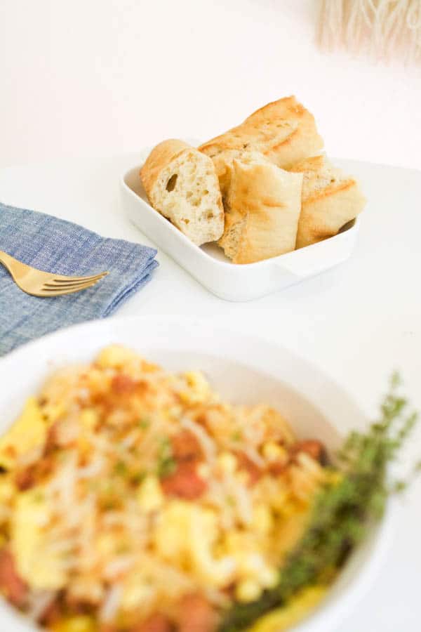 a plate of crusty bread next to a breakfast hash