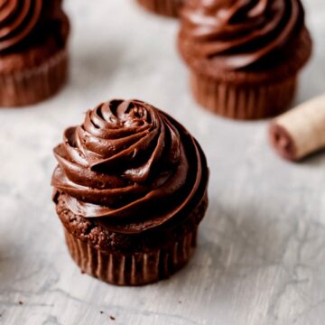 Close up of boozy chocolate cupcakes infused with red wine on a table.