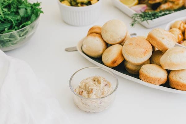 Yummy brown sugar bacon butter in a bowl next to rolls for Thanksgiving.