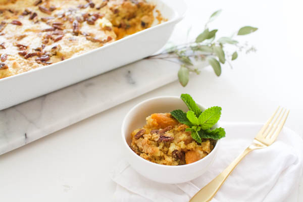 Sweet Potato Dump Cake for Thanksgiving in a small serving bowl next to a baking dish. 