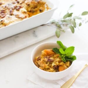 Close up of a small white serving dish with a portion of sweet potato dump cake.