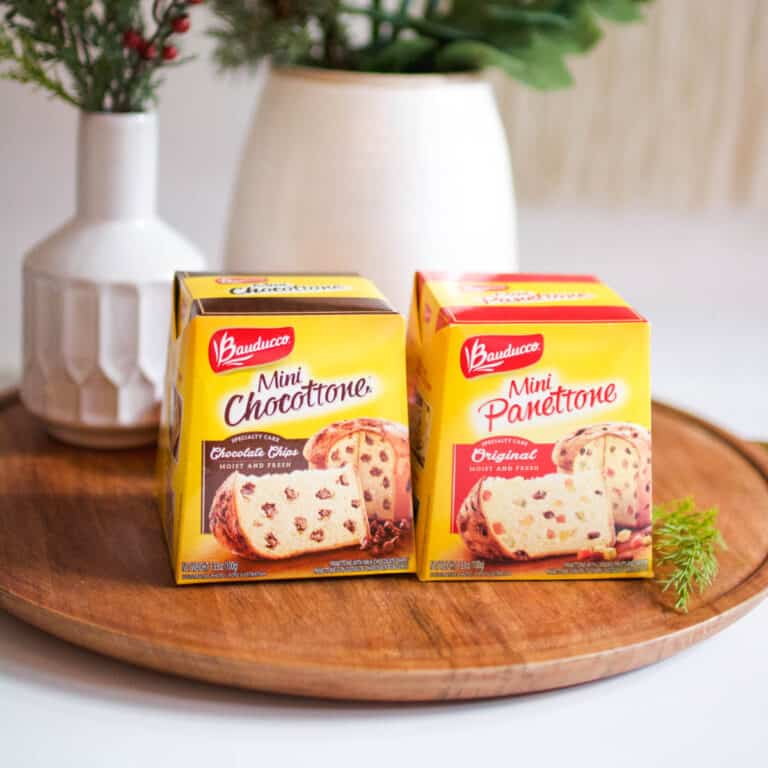 Two yellow boxes of Panettone on a tray on a table.