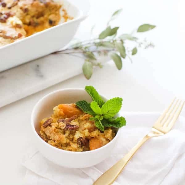 A portion of sweet potato dump cake in a small white bowl. 