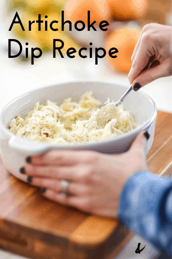 Woman stirring artichoke dip on a counter with text overlay for Pinterst.