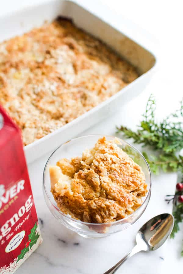 Eggnog dump cake in a baking pan and a small portion in a dessert bowl.  