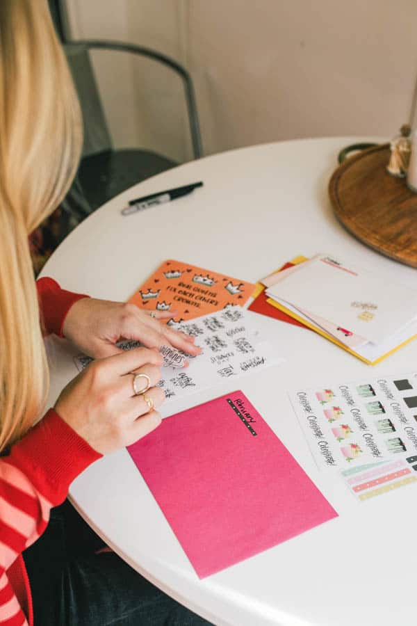 Woman putting sticker on envelope.