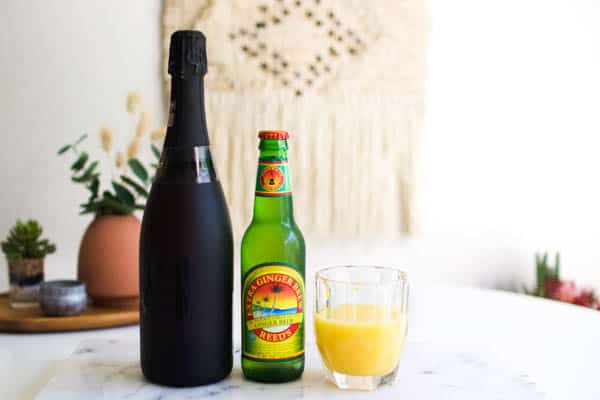 ingredients for a champagne cocktail with orange juice