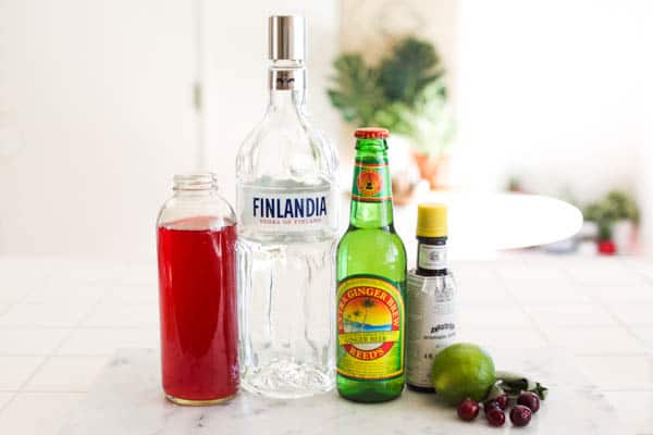 Ingredients for a cranberry moscow mule on a counter.