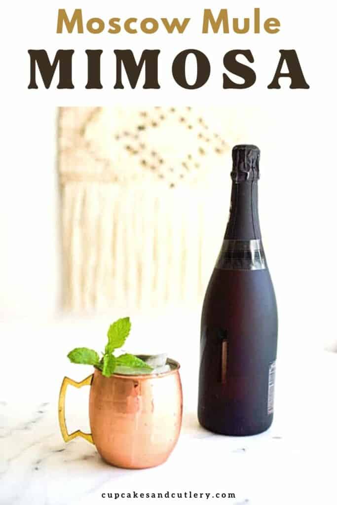 Text - Moscow Mule Mimosa with a Copper Mule mug holding a cocktail next to a bottle of champagne.