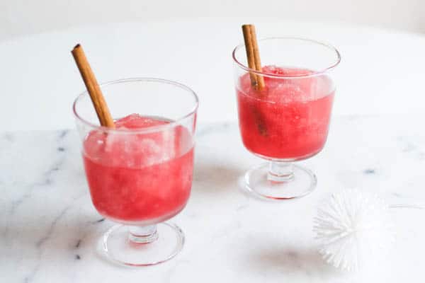 2 glasses of a cranberry vodka slush cocktail.