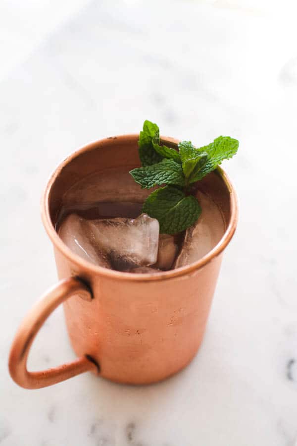 Top of a copper Moscow Mule mug with mint garnish.