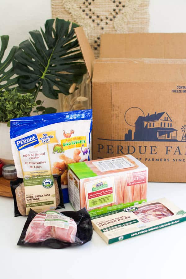 Perdue farms products on a table next to a Perdue Farms shipping box.