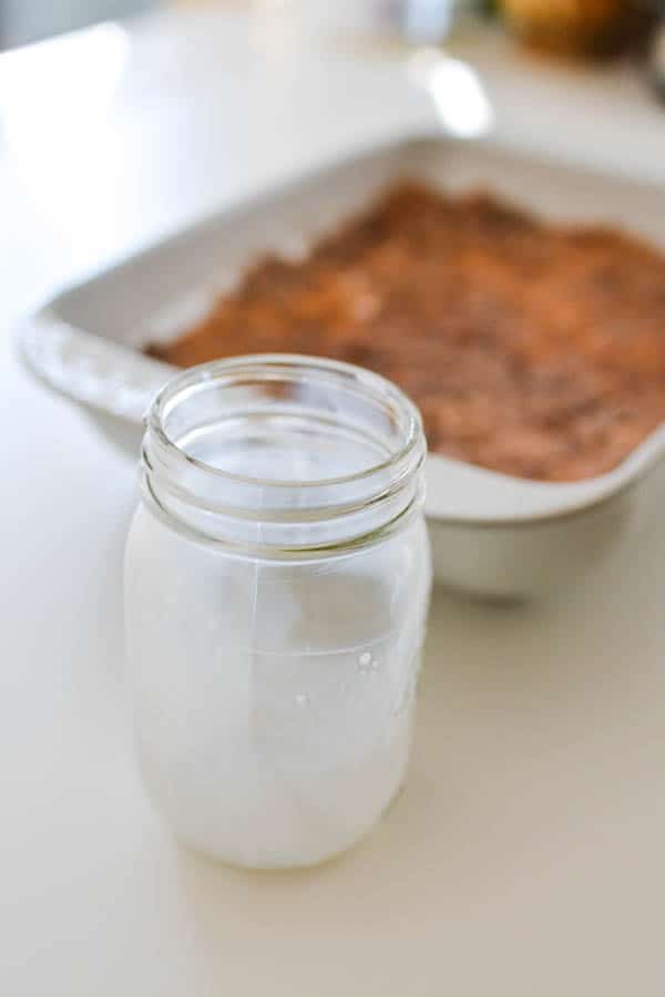 Empty jar of milk to add to chocolate caramel dump cake.