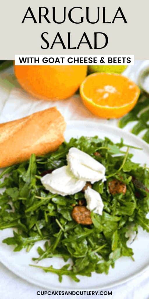 Close up of an arugula salad topped with goat cheese, candied pecans, and beets.