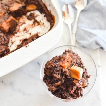 Close up of chocolate caramel dump cake in a serving bowl.