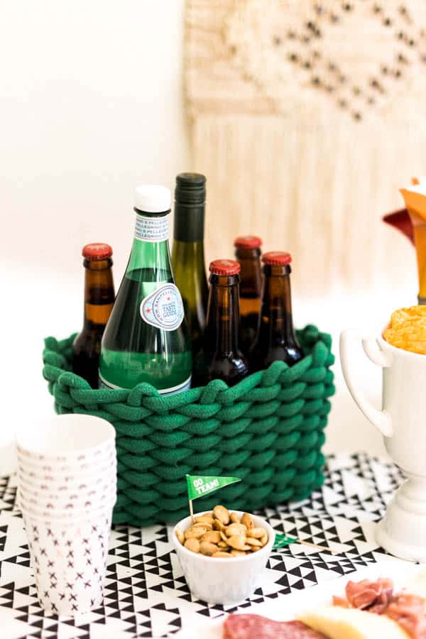 Close up of a basket of party drinks including beer, wine and sparkling water.