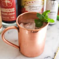 A copper Moscow Mule mug with a mint garnish.