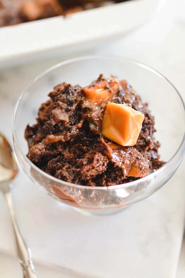 Close up of a portion of gooey and chocolatey dump cake with caramel.