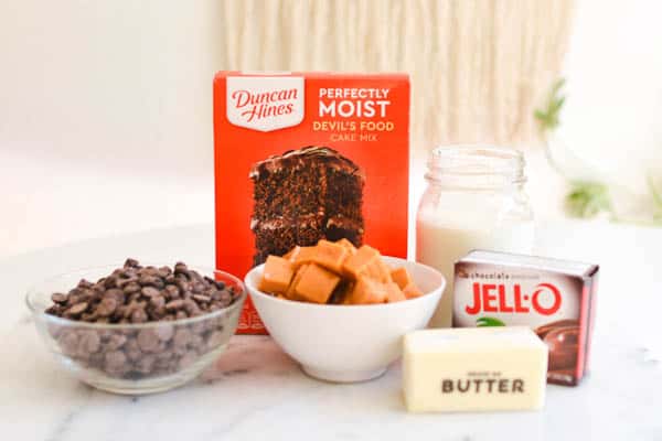 Ingredients to make a Chocolate Caramel Dump Cake recipe on a cutting board.