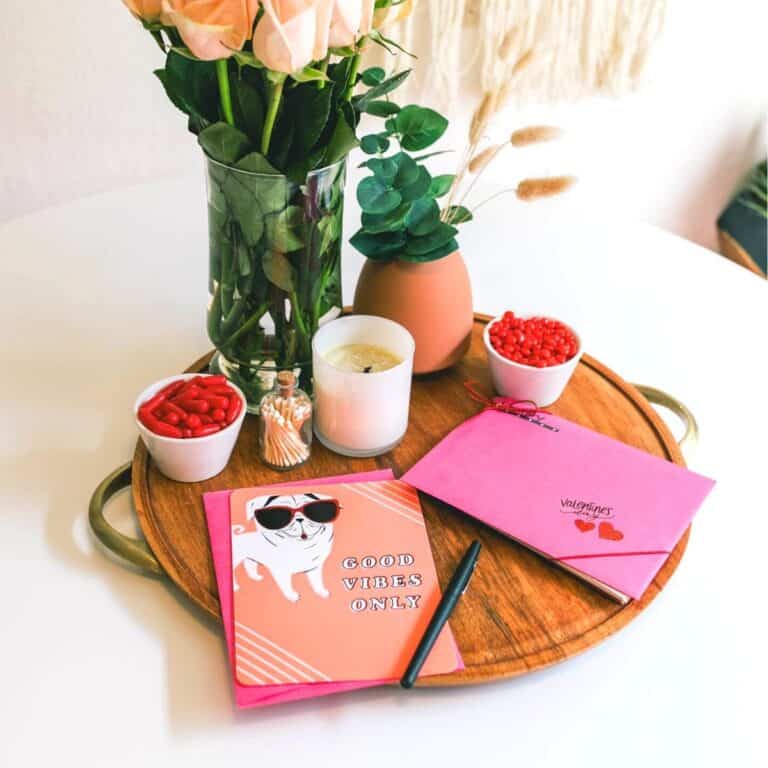 Lazy susan topped with flowers, candles and gift cards.