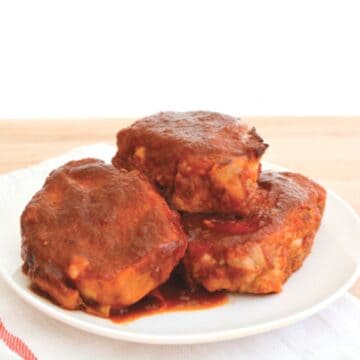 Close up of oven baked pork chops in a sweet and sour sauce.