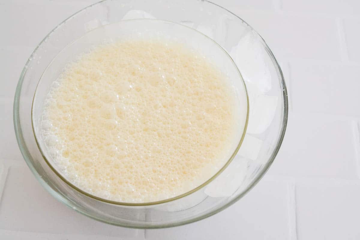 A small bowl with a creamy mixture in a bowl sitting in a larger bowl with ice.