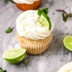 Close up of a frosted cupcake with a lime wedge