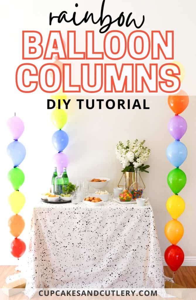 Image contains a table surrounded by three rainbow balloon columns and text that reads Rainbow Balloon Columns DIY Tutorial.