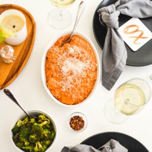 Overhead image of a serving dish with farro topped with rosa sauce.