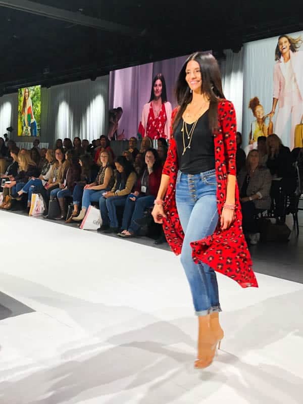 Woman modeling clothing on a runway.