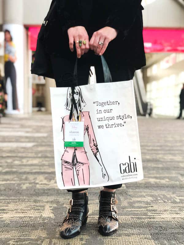 Woman holding a reusable shopping bag.