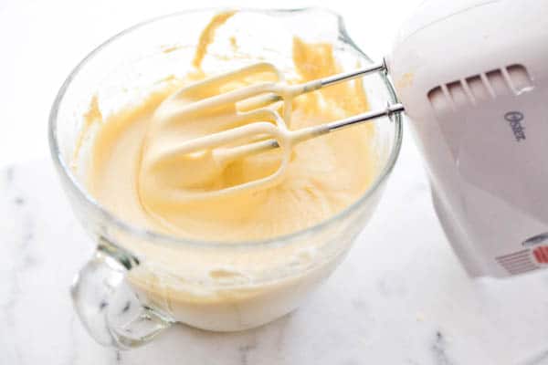 soda cake batter in a bowl with a mixer