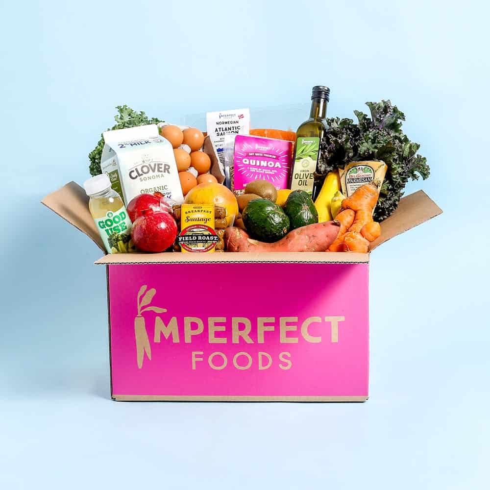 Box that says Imperfect Foods and has fresh veggies and other products sticking out the top.
