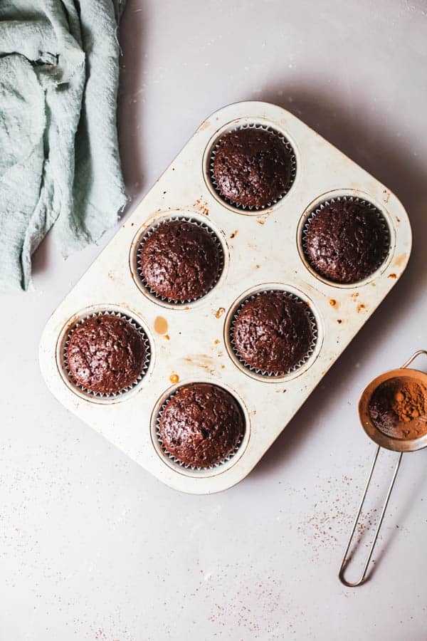 Overhead shot of chocolate cupcakes in a muffin pan. 