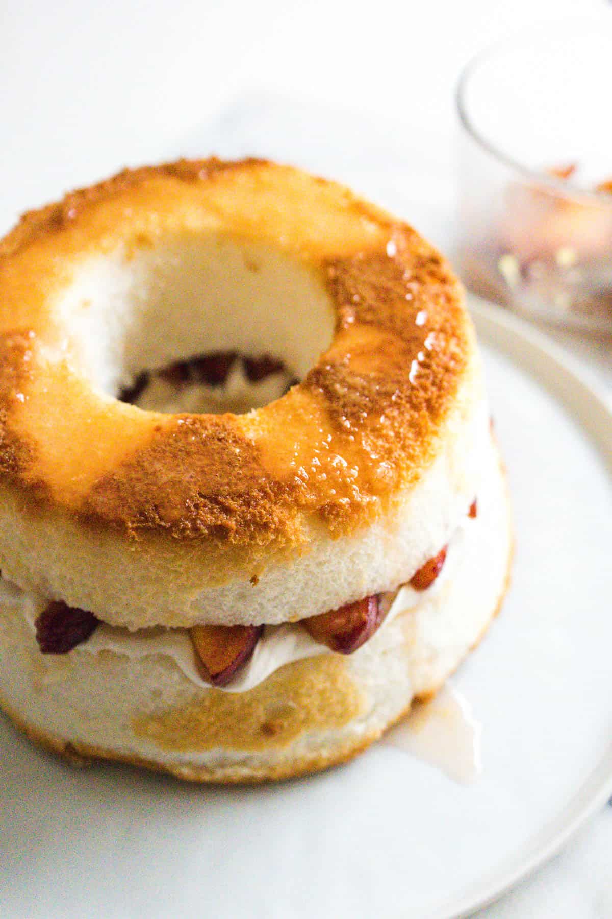 Angel food cake cut in the middle and layered with Cool Whip and gingered peaches with the juice poured on top.