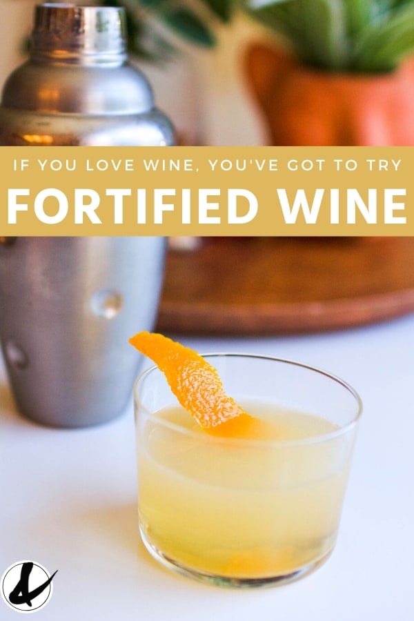 Fortified wine in a glass with a cocktail shaker in the background. 