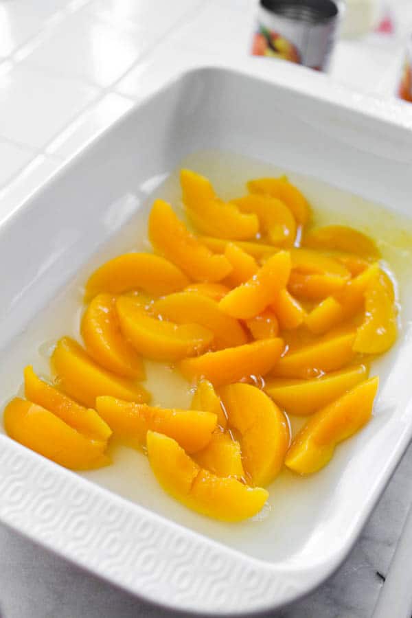 Canned peaches in a baking dish.